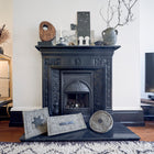 A large square, oblong and round Chimney Sheep standing in front of an open fire which has a removeable chimney blocker in place.