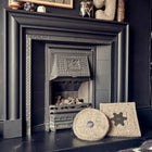 Two wool Chimney blockers in front of a fireplace.